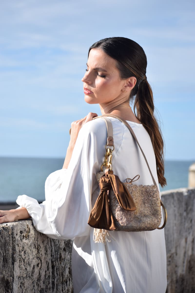 Model with a handcrafted handbag on her back